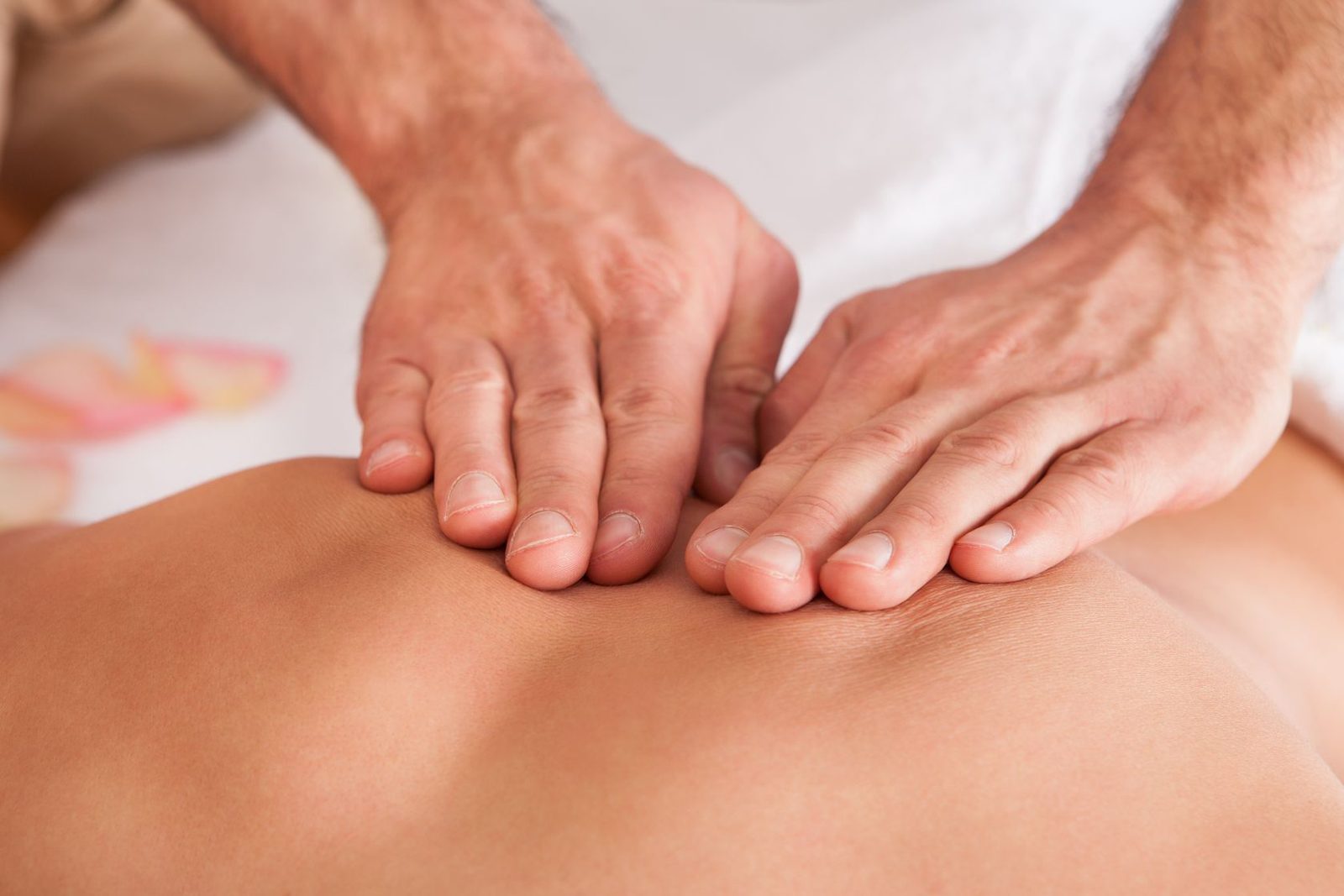 Therapist's hands giving a deep tissue massage in our Burlington studio